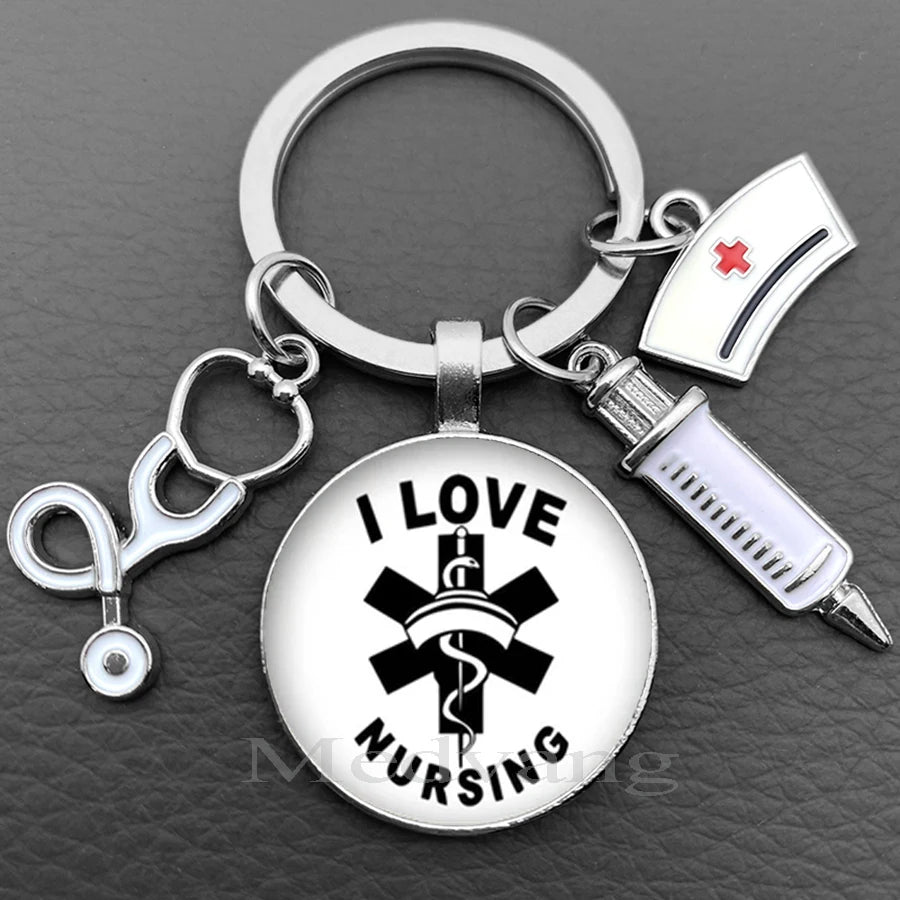Silver keychain featuring a circular charm with a black medical cross and the words I LOVE NURSING
