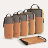A set of six tan and gray expandable compression packing cubes are displayed on a white background.