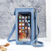 Helles blaues durchsichtiges Multifunktions-Crossbody-Handybeutel mit goldener Reißverschluss und Trageriemen vor grauem Hint