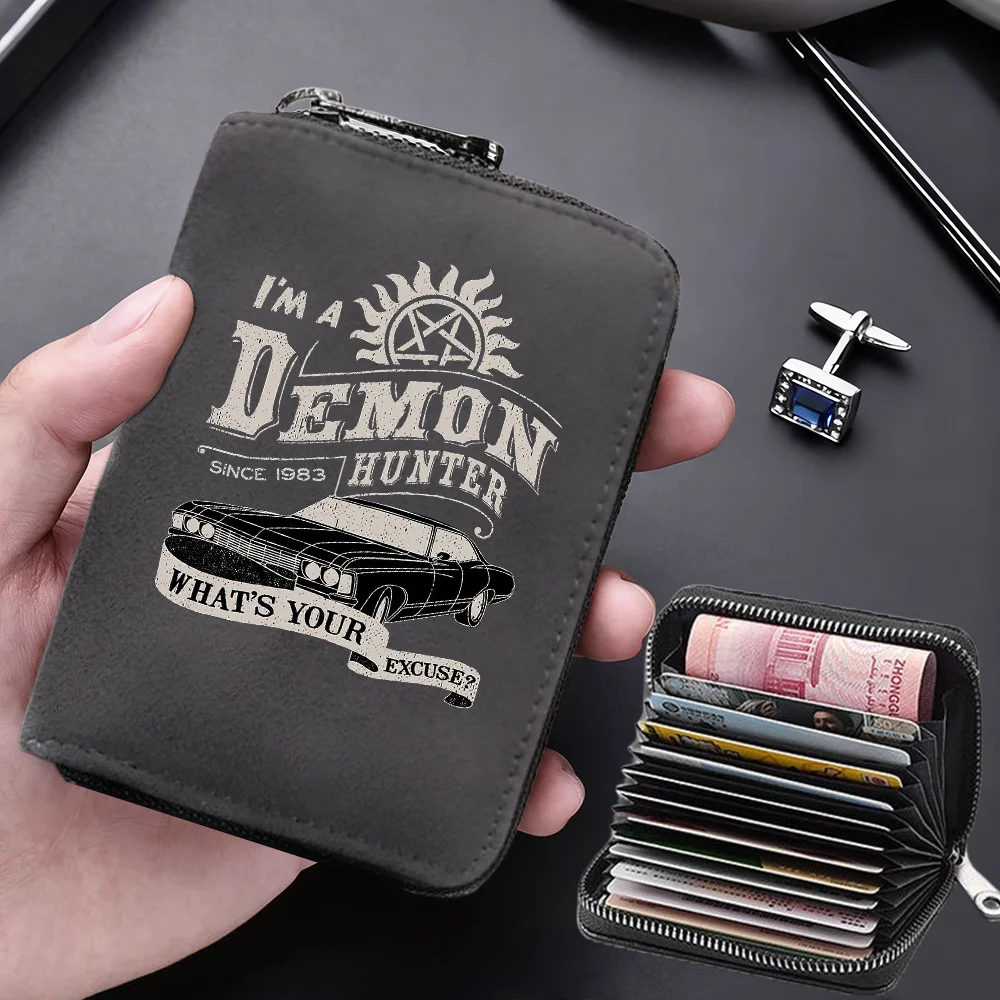 A dark gray leather card wallet featuring a demon hunter design and holding several credit cards.