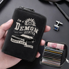 A black leather card wallet featuring a demon hunter design and holding several credit cards.