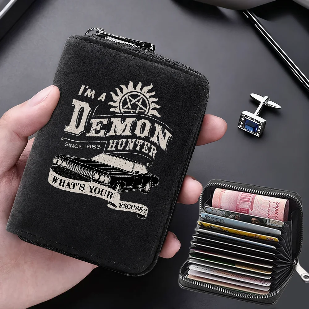 A black leather card wallet featuring a demon hunter design and holding several credit cards.