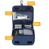 A dark blue portable waterproof toiletry washbag with a hanging design, showing compartments for toiletries and a mesh storag