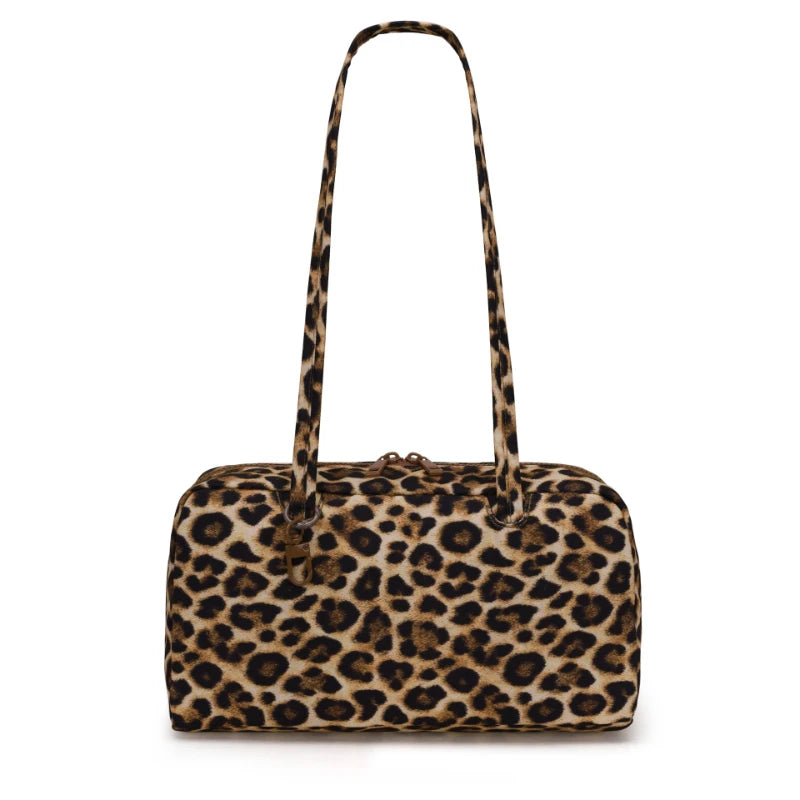 A leopard print nylon shoulder tote bag with a long strap.