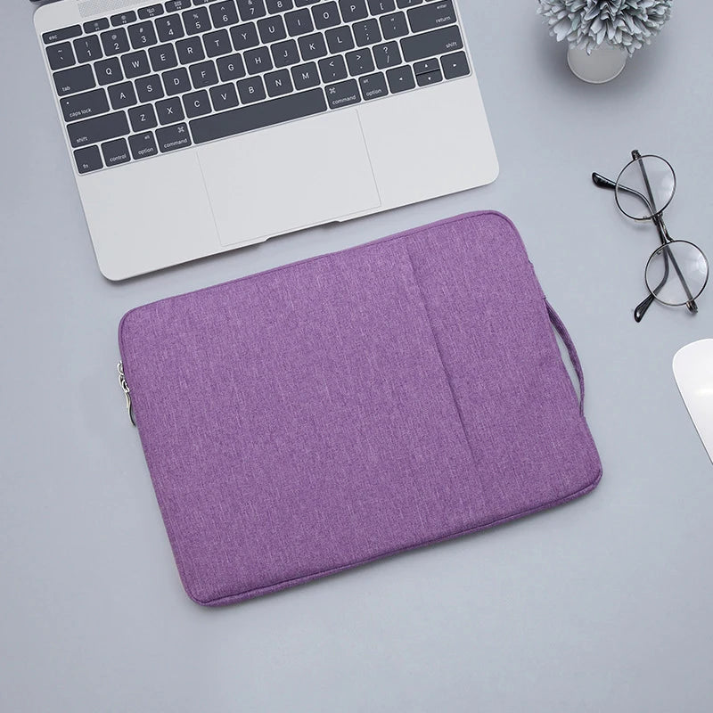 A purple laptop sleeve is shown next to a silver laptop and a pair of black glasses.