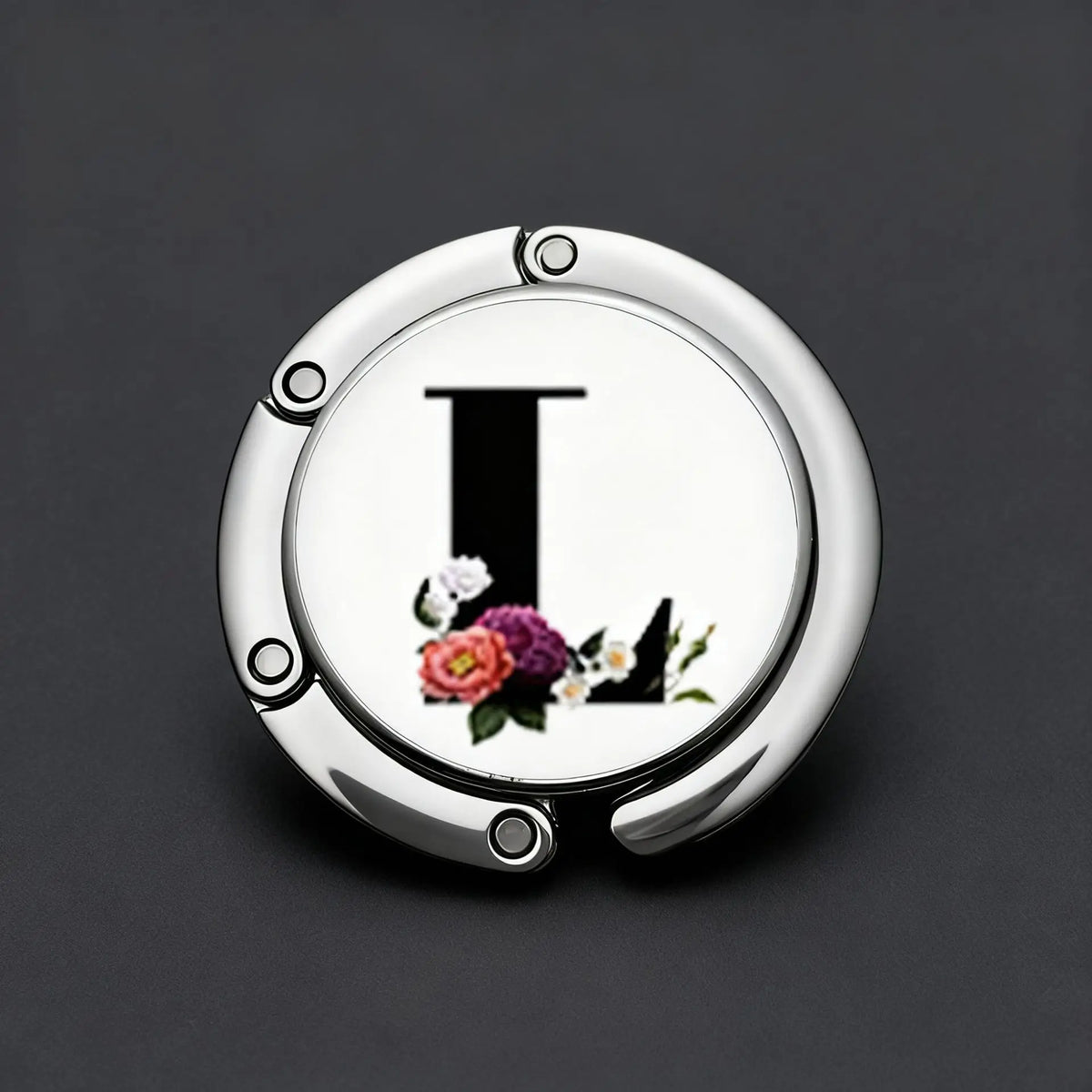 Silver foldable letter Hanger hook with floral accents on a dark gray background.
