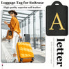 Black luggage tag with gold letter A embossed on a black fabric for suitcase identification