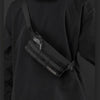 A black vintage style multifunctional chest bag worn on a person's torso.