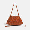 A brown handwoven PU shoulder bag with a woven texture is displayed against a white background.