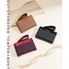A collection of brown, black, and burgundy women's zip-around wallets displayed on a light background.