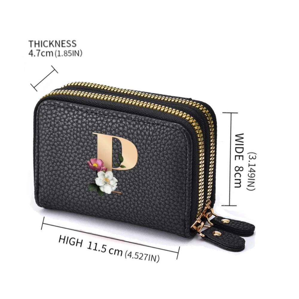 Black floral letter print mini wallet with a gold zipper detail shown from the side.