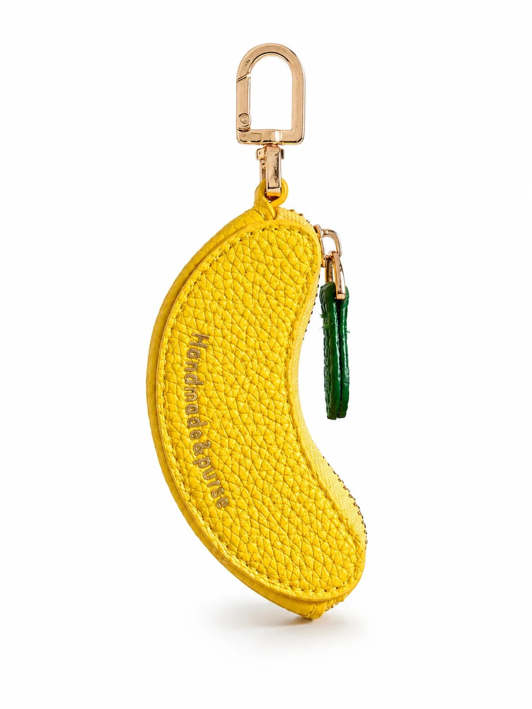 A yellow fruit-shaped PU leather coin purse keychain with a gold-tone clasp and green tassel.