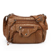A brown luxury leather tote bag with multiple zippered compartments and a flap closure.