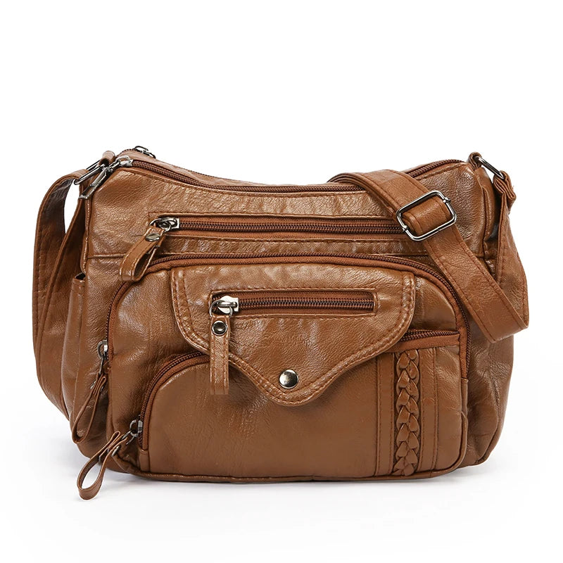 A brown luxury leather tote bag with multiple zippered compartments and a flap closure.
