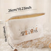 White corduroy makeup storage pouch with a floral pattern shown lying on lace fabric