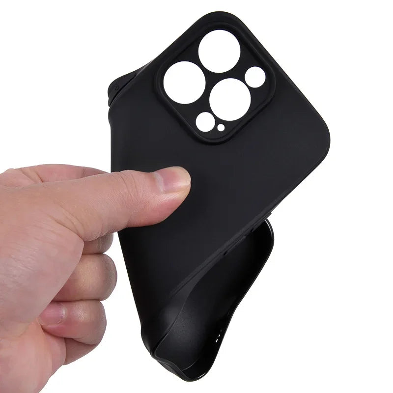 A hand holds a black phone case with a vintage cassette tape design and a cutout for the camera module.