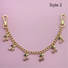 Gold decorative chain necklace with small green charms for bags and clothing