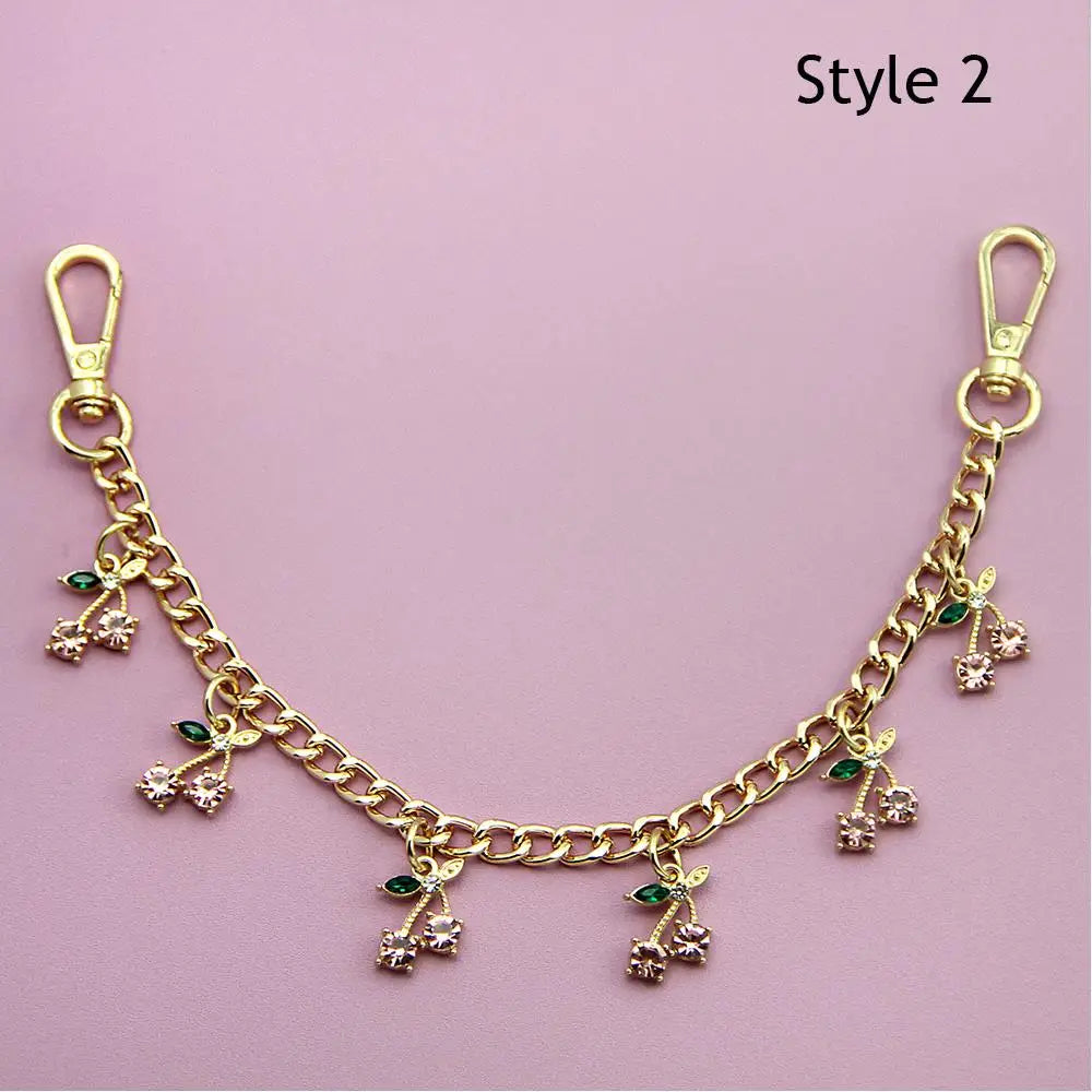 Gold decorative chain necklace with small green charms for bags and clothing