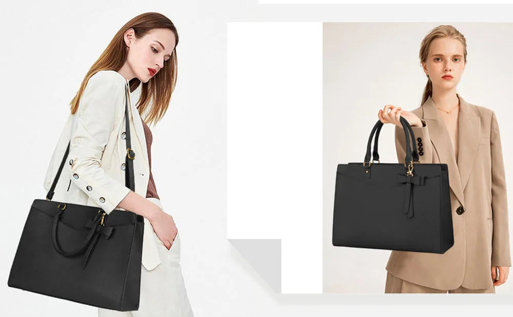 A woman holds a black premium PU leather laptop tote bag in a light beige blazer.