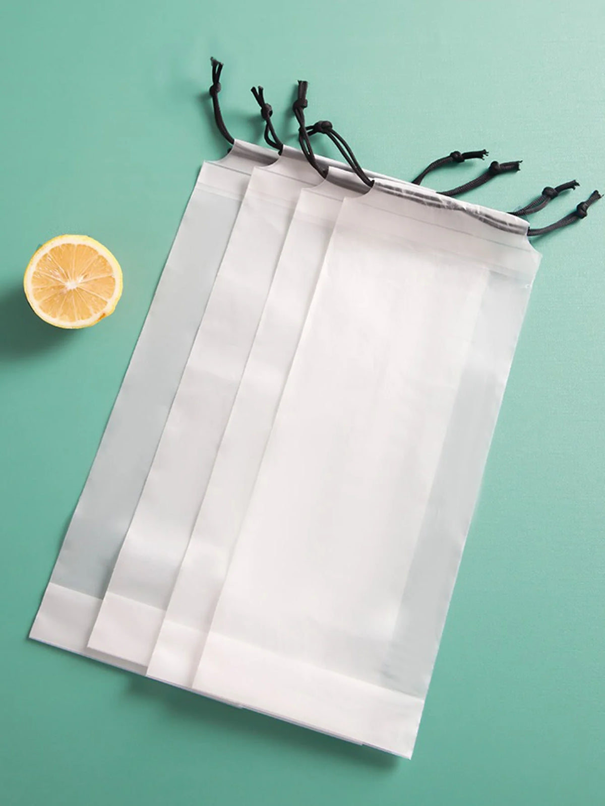 A white heavy-duty windproof automatic umbrella is displayed against a teal background with a slice of lemon nearby.