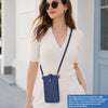 A woman models a light beige mini PU leather crossbody phone bag with a navy strap and white outfit.