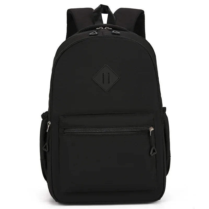 A black durable nylon commuter backpack shown from the back.