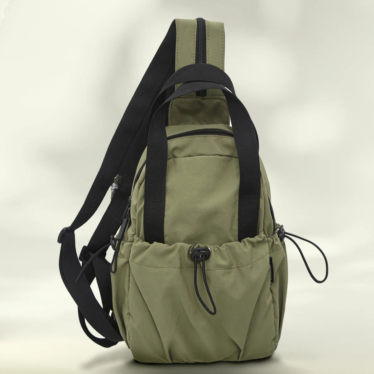 A olive green casual backpack with black straps and a laptop compartment shown from the back.