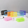 A collection of colorful transparent PVC travel makeup bags with zipper closures arranged on a white surface.