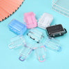 A collection of miniature doll suitcases in various colors including pink, purple, and clear plastic on a light blue backgrou