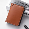 A brown leather credit card wallet is shown resting on a white box with a black pen.