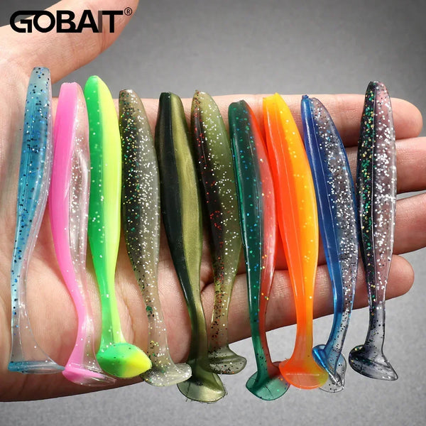 A hand holds a variety of colorful adjustable soft lure fishing tackle lures.