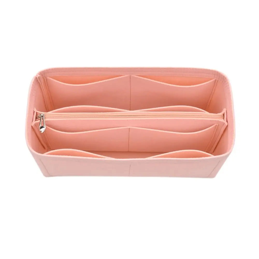 A pink felt insert liner designed for handbags, showing the interior divided compartments.