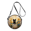 A black cartoon cat round crossbody bag with a thin black strap, featuring a floral design.