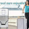 A woman stands next to two silver suitcases with a transparent PVC luggage cover set in an airport setting.