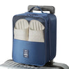A blue portable luggage shoe organizer bag with mesh pockets is shown on a silver suitcase.