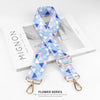 A light blue and purple patterned nylon bag strap is displayed on a white background.