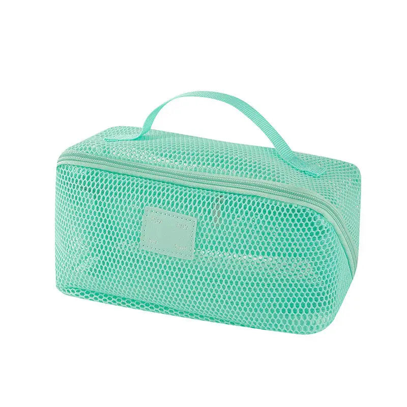 A mint green mesh cosmetic organizer pouch with a handle.