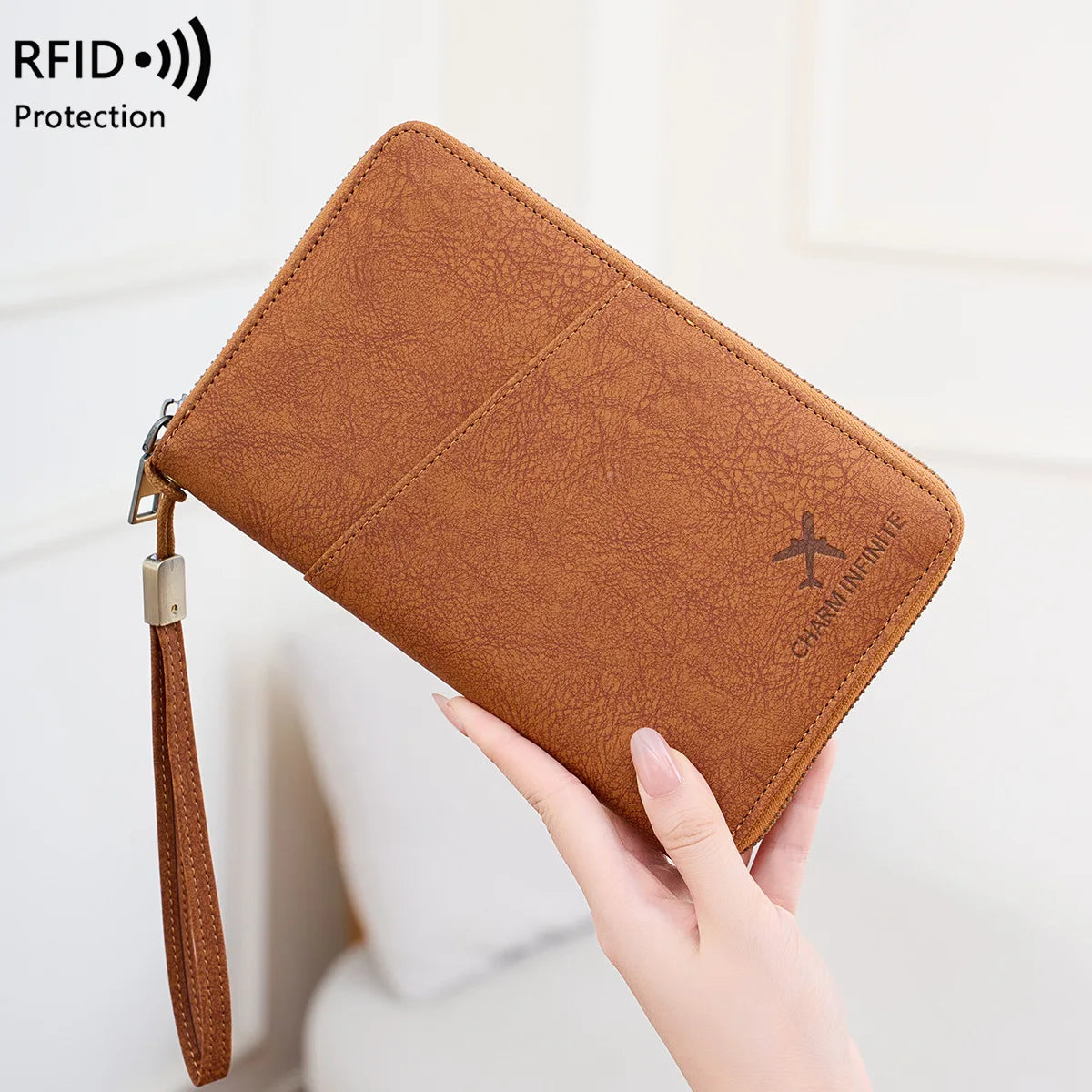 A brown leather RFID blocking passport and document holder being held by a hand.