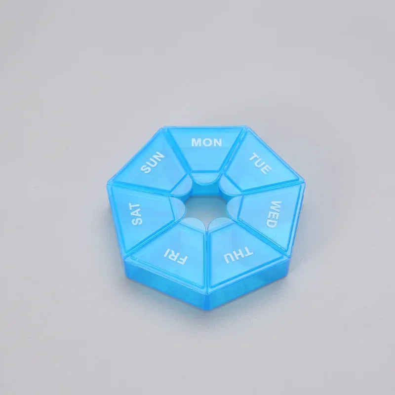 A clear blue 7-day weekly pill organizer divided into seven sections labeled with the days of the week.