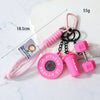 Pink fitness dumbbell keychain charm with a pink cord and black chain.