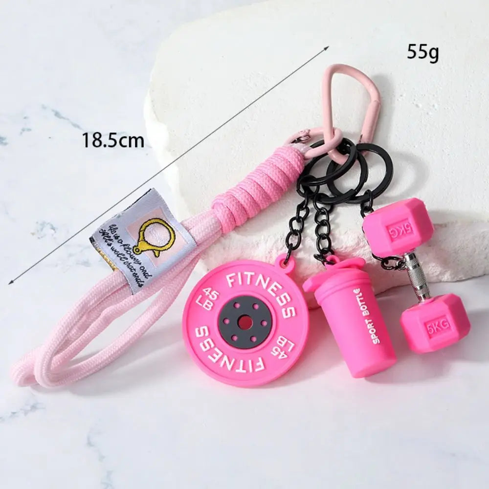 Pink fitness dumbbell keychain charm with a pink cord and black chain.