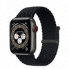 A black braided solo loop stretch band is shown next to an Apple Watch.