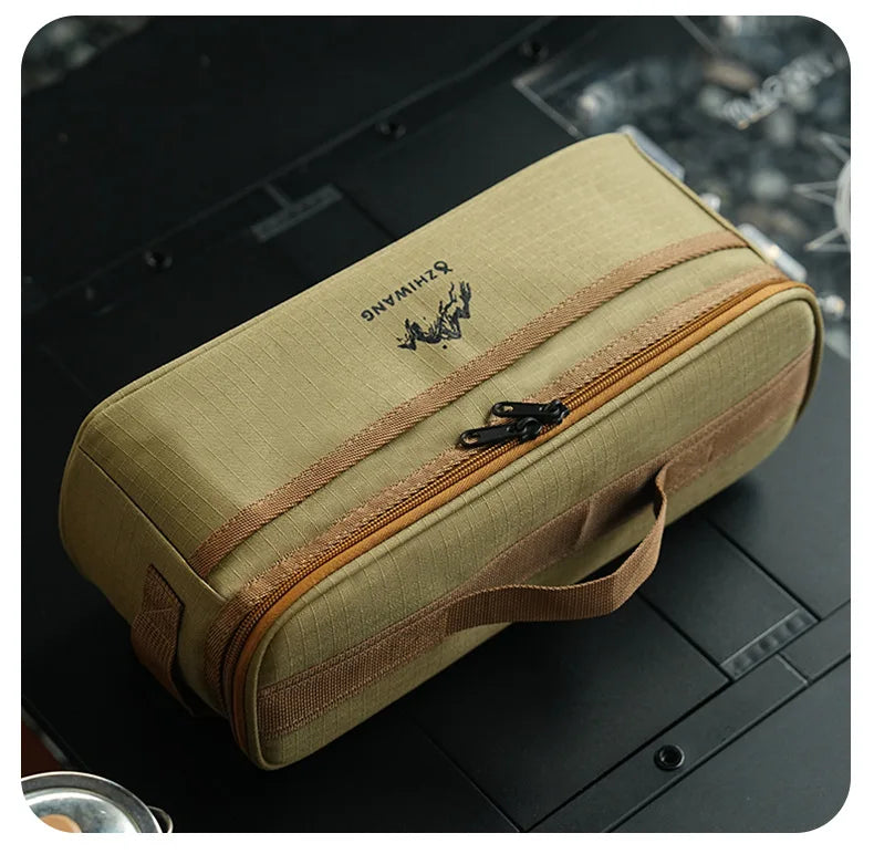 A beige fabric organizer case with a zipper and leather strap is shown on a dark surface.