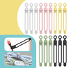 A collection of silicone cable ties and cord organizers in various colors including white, pink, and yellow.