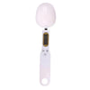 A white digital kitchen scale with a round glass weighing platform and a handle.