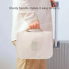 A person is carrying a light beige waterproof makeup organizer and travel pouch with a sturdy handle.