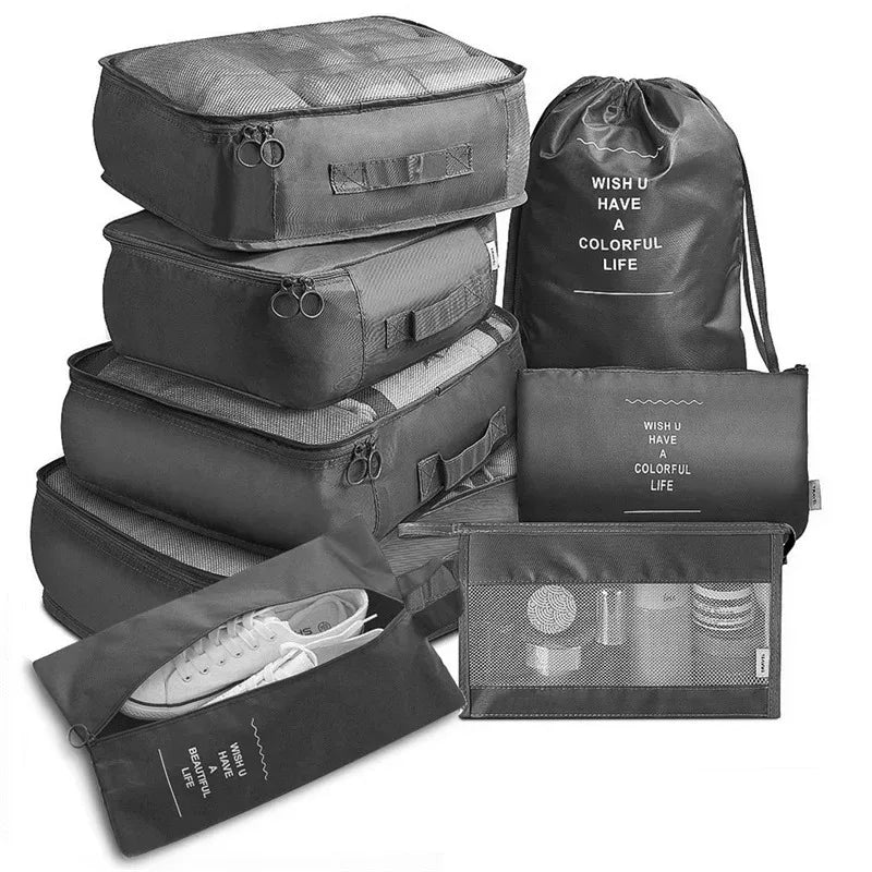 A set of black mesh packing cubes and a drawstring bag for travel organization.