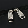 Silver metal zipper pulls attached to a black travel backpack