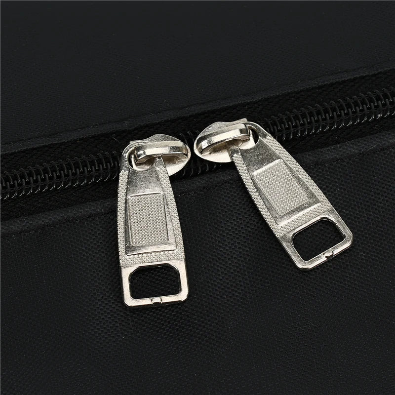 Silver metal zipper pulls attached to a black travel backpack