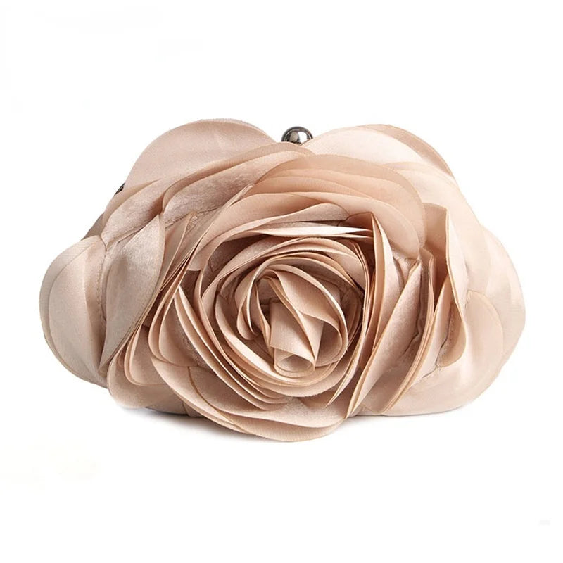 A soft blush pink rose floral evening clutch bag with a chain strap.